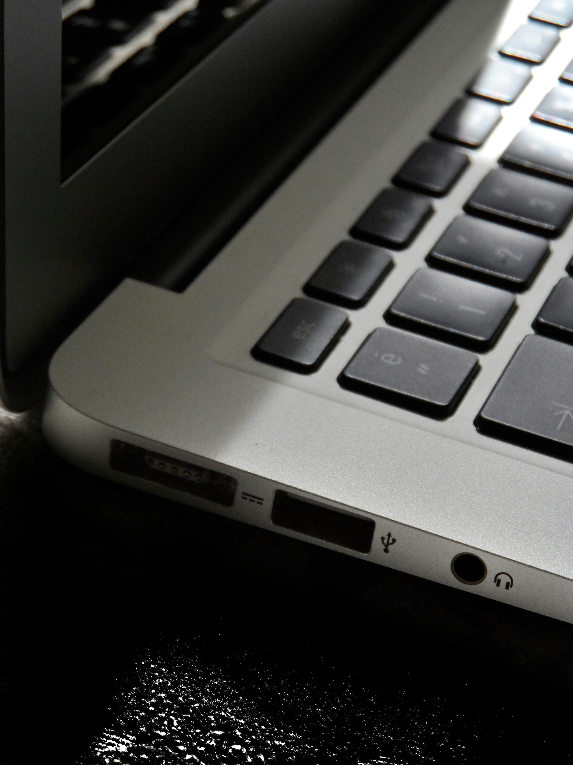 Free Detailed view of a silver laptop showing keyboard and multiple ports. Stock Photo